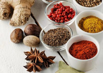 Food_ Spices in bowls on a white table by Ina Peters - Stocksy United